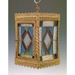 Victorian pressed brass framed hall lantern having four stained and leaded glass panels, 30.5cm high