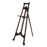 Carved mahogany and beech floor standing easel standing on scroll supports, overall height 166cm