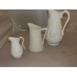 THREE WHITE GLAZED WATER JUGS 12",8"  6" TALL MOULDED RELIEF VINE & WHEAT DECORATION