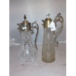 PLATED CLARET JUG ON A TAPERING CUT GLASS FLAT BASE WITH CAST METAL HANDLE TOPPED WITH LION & KNOB &