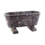 A miniature Roman African marble bath standing on four paw feet on two rectangular bases late 19th