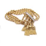 A 18K gold and diamond sliding clasp bracelet The bracelet is composed of cords with tassel endings,