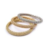 A set of three 18K rose, white gold and gold braceltets Woven elaborated, length 19 cm peso 119,1
