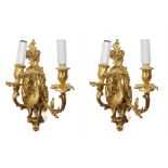 A pair of French ormolu two-branch wall-lights Finely chased and decorated with flowers, foliage and