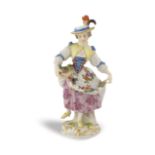 A Meissen porcelain figure On a roccaille base, mark under the base, minor defects on the flower