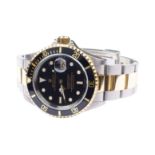 A steel and gold Rolex Oyster Perpetual Date Submariner 40 mm. diameter dial with gold rim, sapphire
