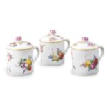 A Meissen set of three porcelain cups Decorated with fruits and flowers, gilt rim, mark under the