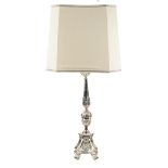 A silvered metal torch holder electrified and decorated with scroll-shaped and foliage elements,