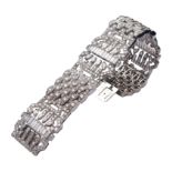 A platinum and diamond geomteric band bracelet Brilliant-, baguettes- and navette-cut diamonds of