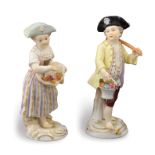 A pair of Meissen porcelain figures Modelled as two noble children with fruit baskets, mark under