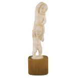 An extraordinary Chinese ivory figure Modelled as two playing children on wooden base early 20th