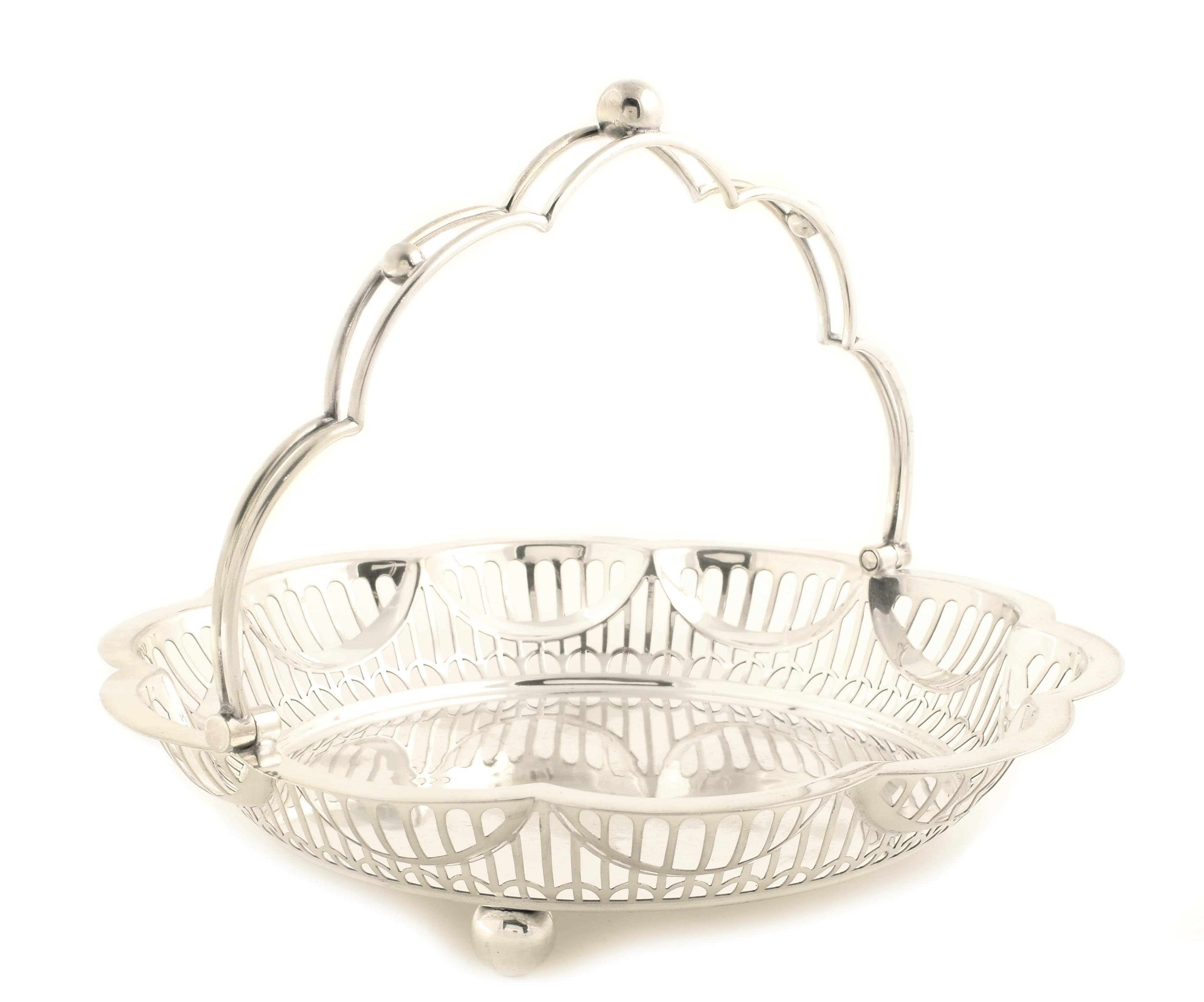 A Sheffield silver basket with handle Pierced rim and standing on four feet England, 20th century