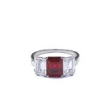 A platinum, ruby and diamond trilogy Bulgari ring Emerald-cut ruby weighing approx. 2,60 carats,