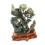A Chinese Jade group Modelled as birds and flowers, wooden base, minor defects 20th century 19x17