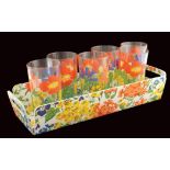 A set of six colored glasses With suiting tray