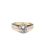 An 18K gold, white gold and diamond ring In the center a brilliant-cut diamond, approx. weighing 2