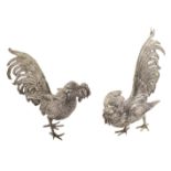 A pair of German silver roosters modelled in fight position, height: 14 cm and 11 cm 20th century