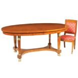 A French mahogany table with six chairs Oval top on four feet with ormolu mountings, comprising