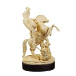 A rare French ivory group the ivory is finely decorated and modelled as Saint George sitting on