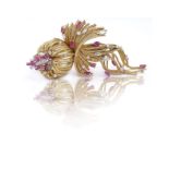 An 18K gold cordonne' and ruby brooch Oval-cut and marquise-cut rubies approx. weighing 2 carats and