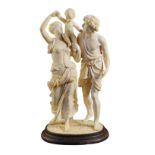 A great French ivory group modelled and finely engraved as a young family standing on an ebonized