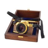 A 24K gold edition Leica R4 camera comprising W/Summilux-R 50mm/f1.4 lens kit and with wooden