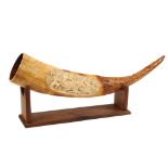 A German ivory horn Decorated with hunting scene engravings, on wooden base 19th century l. 76 cm.