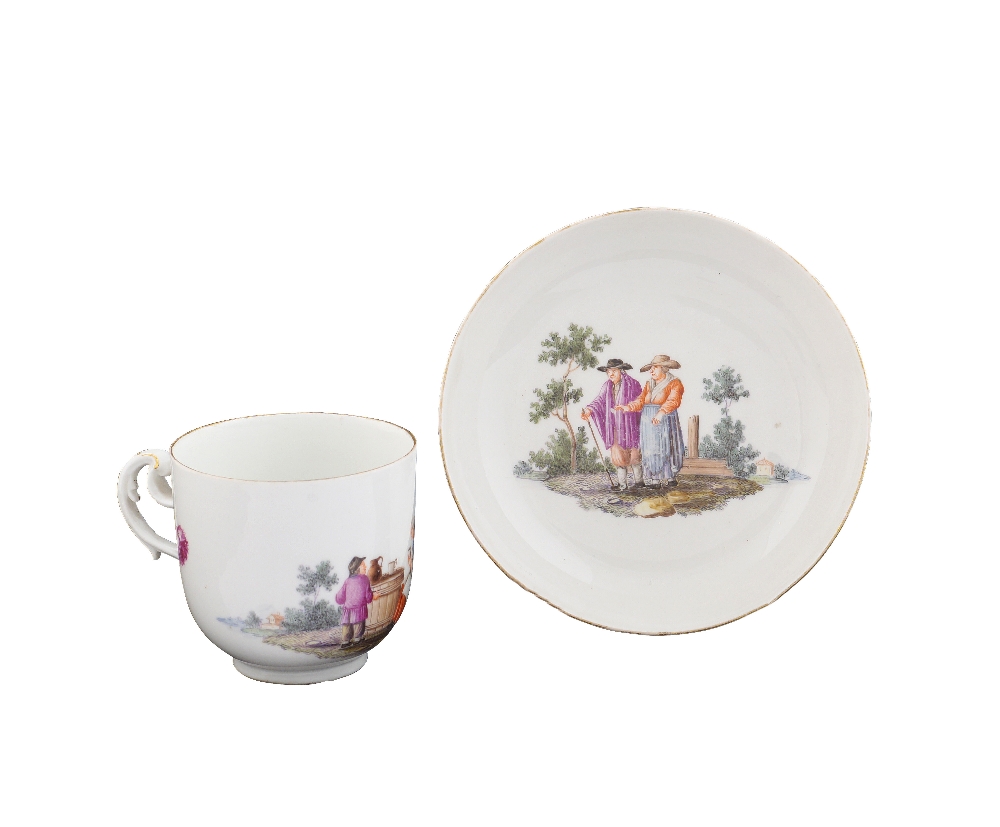 A Meissen porcelain cup with plate Painted with a genre scene in the style of David Terniers, mark