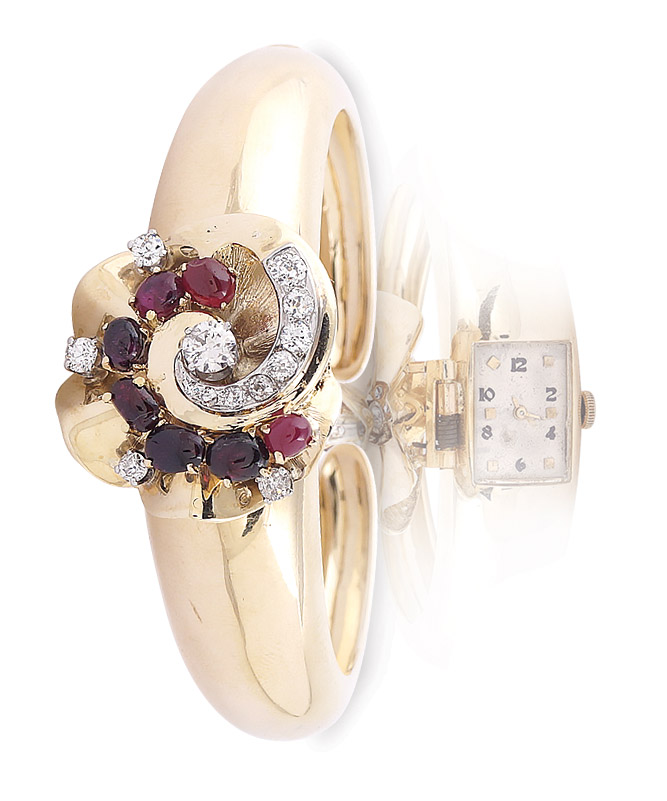 An 18K gold and ruby cuff bangle wristwatch Cabochon-cut rubies of approx. 2 carats, surrounded by