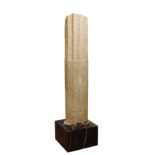 An Ionian-style stone column On black marble base, 25x40x40 cm. _ h. 131x28 cm.