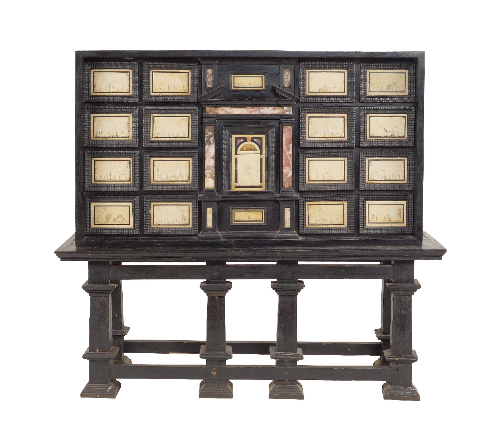 An Italian ebonized wood cabinet a central drawer framed by turned columns with mounted above a Ruin