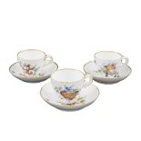 A set of three Meissen porcelain cups White porcelain decorated with fruits and flowers,