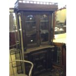 A Continental carved oak glazed bookcase