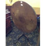 A 19th century mahogany tilt-top occasional table, resting on claw supports.