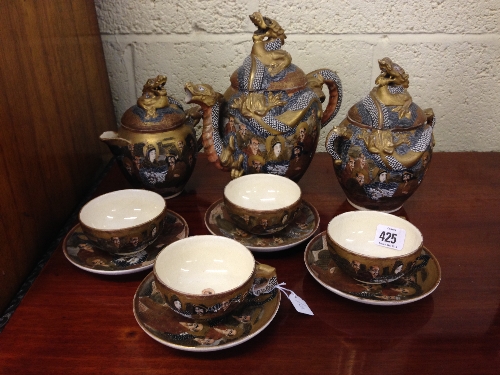 The residue of an early 20th century Satsuma tea service comprising teapot, milk jug and sugar