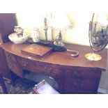 A mahogany bow front sideboard with central drawer, cellarette and side cupboard.