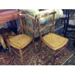 A pair of beech framed Arts & Crafts style bedroom chairs, resting on turned supports.