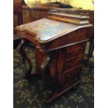 A 19th century walnut davenport with brass railed fitted stationery compartment and lift-top fitted