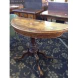 A 19th century walnut revolving demi-lune card table resting on elaborate carved supports (damage