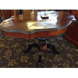 A 19th century serpentine rosewood centre table with two drawers either side,