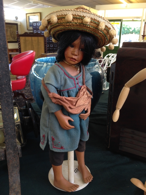 A china headed doll modelled as a Mexican Young Girl.