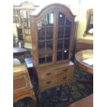 A 19th century inlaid mahogany cabinet on stand with glazed doors and three drawers under,