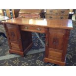 An early 20th century mahogany ladies' writing desk with central drawer and cupboards under.