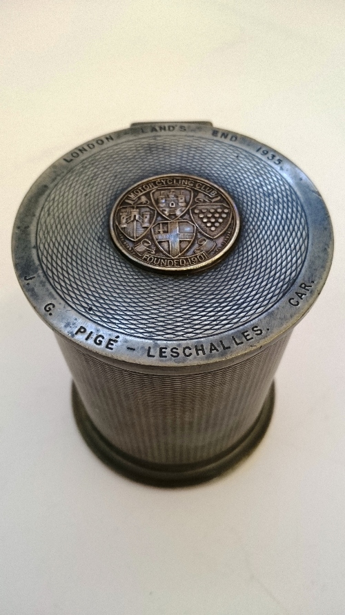 An early 20th century pewter cigarette box with engine turned decoration,
