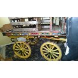 A full size painted and decorated horse drawn open cart with bench seat to front on iron springs