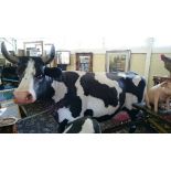 A full size fibreglass model of a black and white Cow.