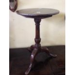 A small 19th century oak occasional table, resting on tripod support.