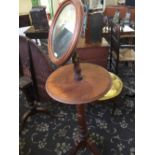 A 19th century oak gentleman's shaving stand with adjustable mirror on brass support.