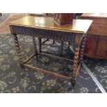 An oak side table with single drawer, resting on bobbin turned cross stretcher supports.