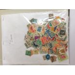 A folder containing a large quantity of mixed stamps, loose and packets.